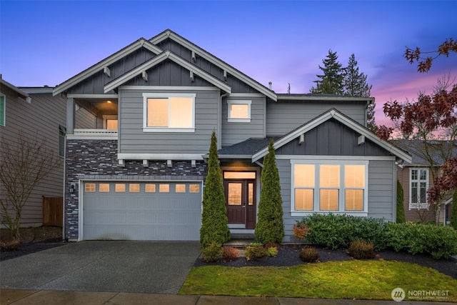 craftsman house with driveway, a garage, and board and batten siding