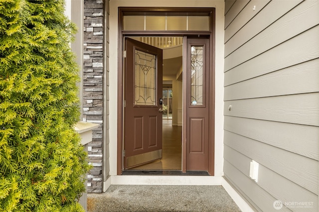 property entrance with stone siding