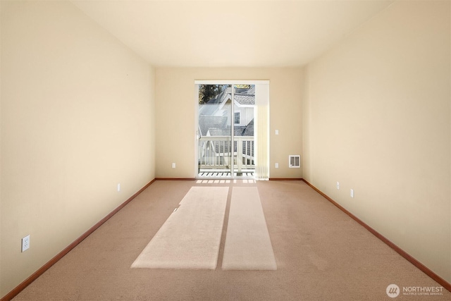 spare room featuring light colored carpet