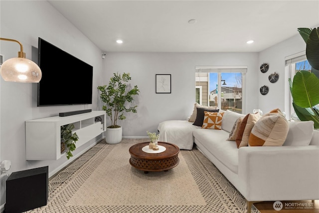 living room with recessed lighting and baseboards