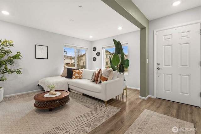 living area with recessed lighting, baseboards, and wood finished floors