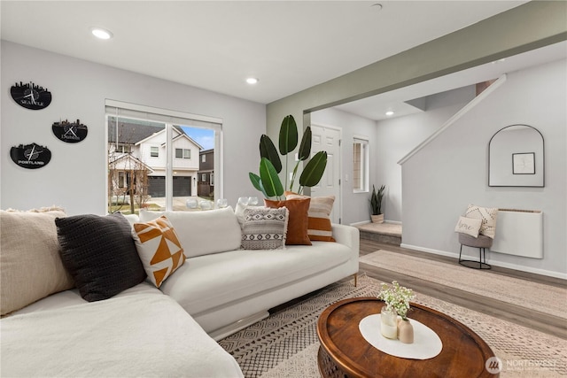 living room featuring baseboards, wood finished floors, and recessed lighting