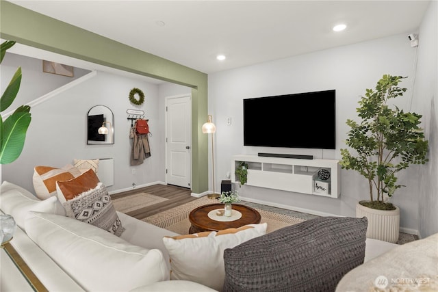 living room featuring recessed lighting, baseboards, and wood finished floors