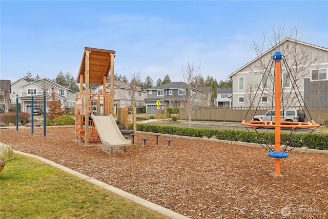 communal playground with a residential view and fence