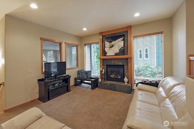 carpeted living room with a healthy amount of sunlight, a large fireplace, and recessed lighting