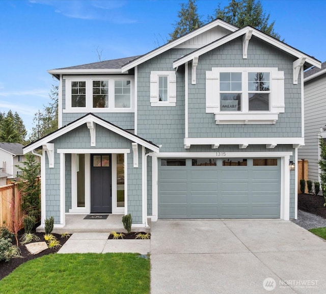 view of front of house featuring an attached garage, concrete driveway, and fence