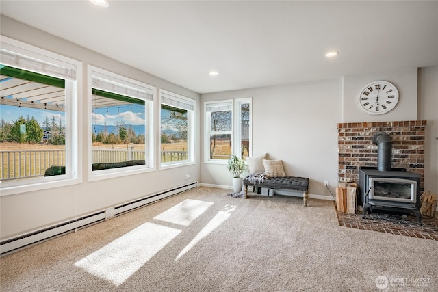 interior space featuring a wood stove and a baseboard radiator