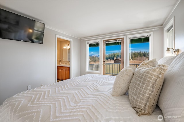 bedroom with multiple windows, crown molding, access to outside, and ensuite bath