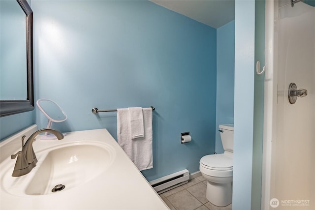 bathroom featuring a baseboard heating unit, toilet, sink, and tile patterned floors