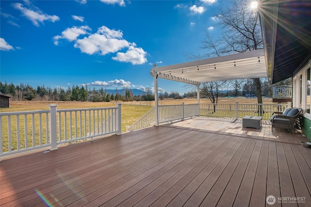 wooden terrace featuring a lawn and a pergola