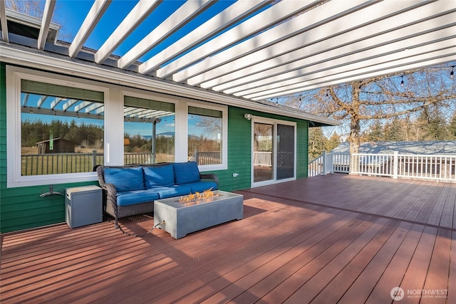 wooden terrace featuring an outdoor living space with a fire pit