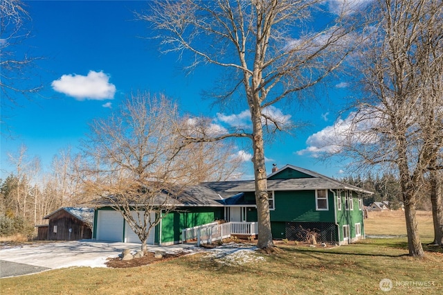 ranch-style home with a front lawn, a porch, and a garage