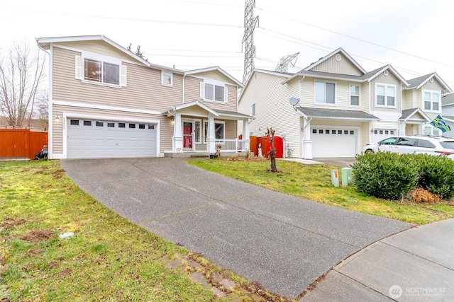 view of front of property featuring a front lawn, a porch, and a garage