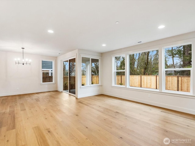 interior space featuring a chandelier, recessed lighting, light wood-type flooring, and baseboards