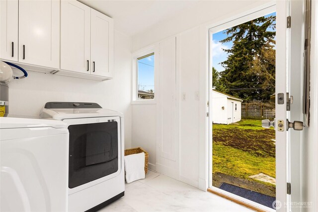 washroom with separate washer and dryer and cabinet space