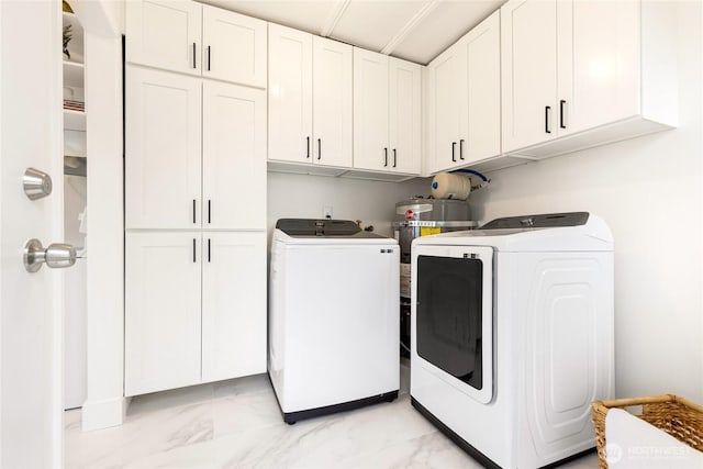 washroom with cabinet space, marble finish floor, and washer and dryer