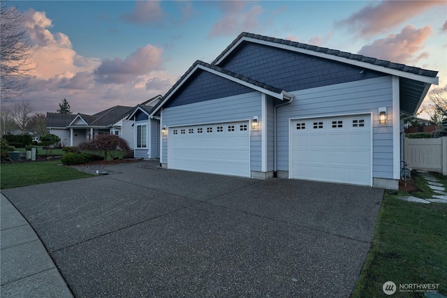 view of front of home with a garage and a yard