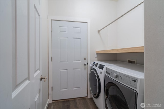 laundry room featuring dark wood-type flooring and separate washer and dryer