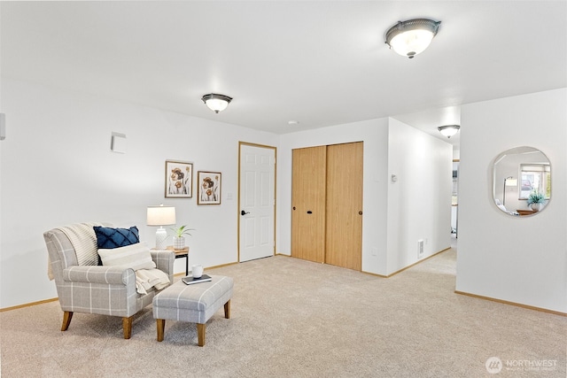 sitting room featuring light carpet