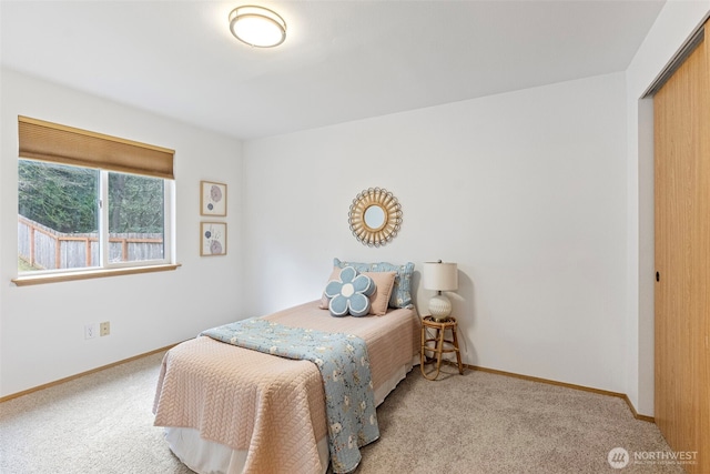 bedroom featuring light carpet and a closet