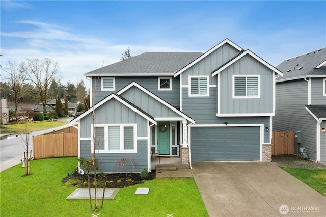 view of front facade featuring fence, concrete driveway, roof with shingles, a front lawn, and board and batten siding