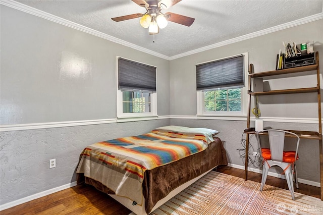 bedroom with ceiling fan, ornamental molding, wood-type flooring, and a textured ceiling