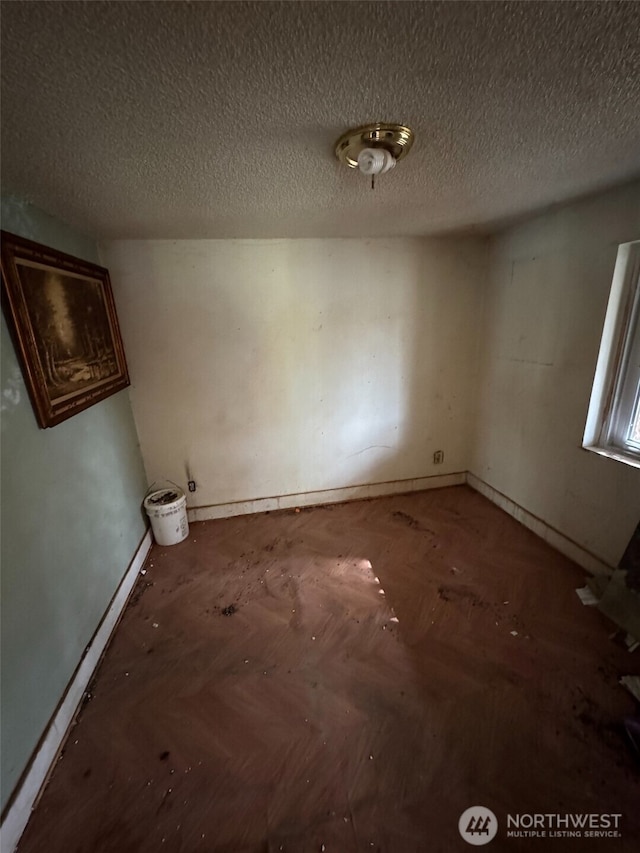 empty room with a textured ceiling