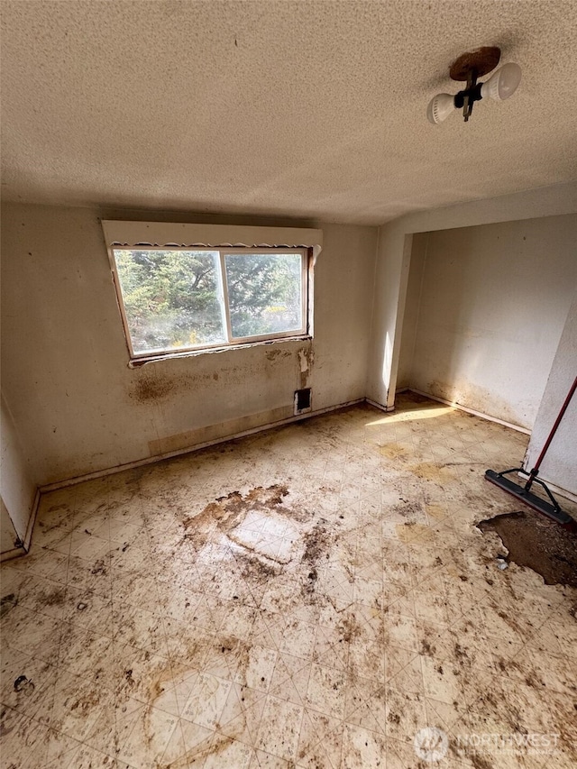 empty room featuring a textured ceiling