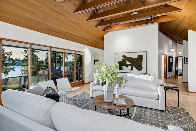 living room with wooden ceiling, rail lighting, light hardwood / wood-style floors, and beam ceiling