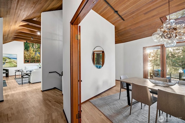 dining space with light wood-type flooring, vaulted ceiling, wooden ceiling, and a wealth of natural light