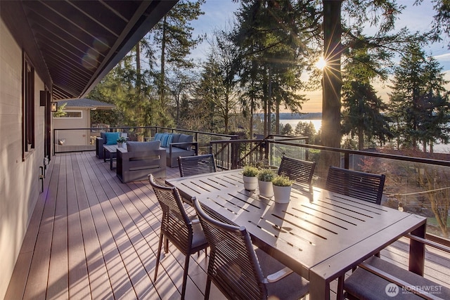 deck at dusk with an outdoor hangout area