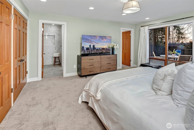 bedroom with light carpet and ensuite bath