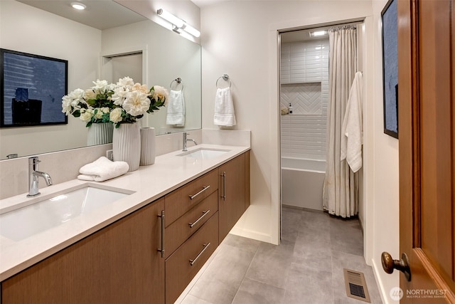 bathroom with tile patterned floors, shower / bath combo, and vanity