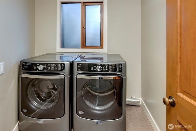 clothes washing area with washer and dryer