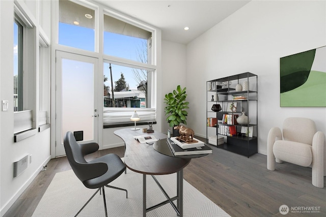 office space featuring recessed lighting, wood finished floors, visible vents, and baseboards