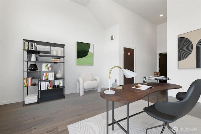 office featuring baseboards, high vaulted ceiling, wood finished floors, and recessed lighting