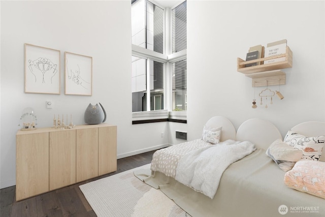 bedroom featuring dark wood-style floors and baseboards