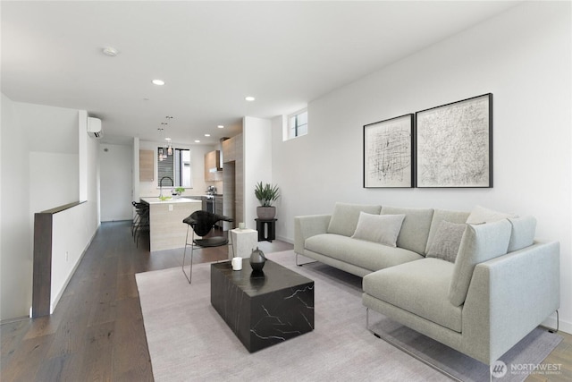 living room with dark wood-style floors, recessed lighting, baseboards, and a wall mounted AC