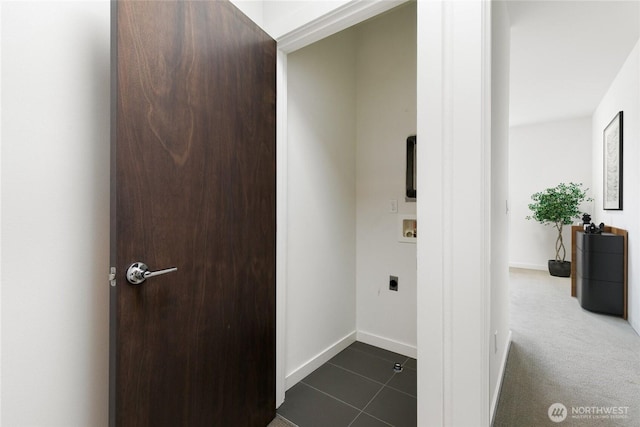 corridor featuring dark tile patterned floors, baseboards, and dark colored carpet