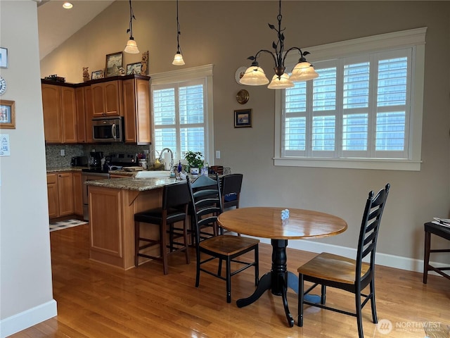 2611 Sea Crest Ave N, Long Beach, WA 98631 - dining room with light wood-style floors, high vaulted ceiling, and a chandelier