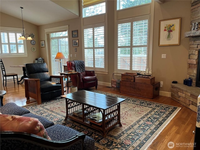 2611 Sea Crest Ave N, Long Beach, WA 98631 - living area with healthy amount of natural light, wood finished floors, lofted ceiling, and a chandelier