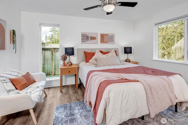 bedroom with a ceiling fan and wood finished floors