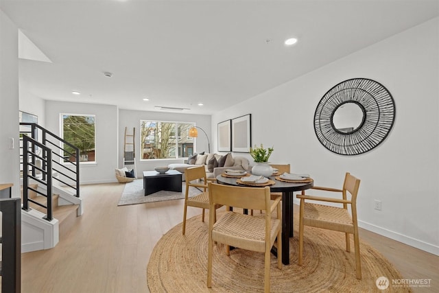 dining room with stairs, recessed lighting, baseboards, and light wood-type flooring