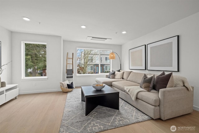 living area with visible vents, recessed lighting, wood finished floors, and baseboards