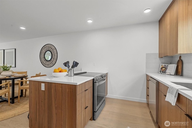 kitchen with tasteful backsplash, modern cabinets, white dishwasher, and stainless steel range with electric cooktop