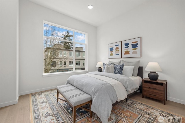 bedroom with recessed lighting, baseboards, and wood finished floors