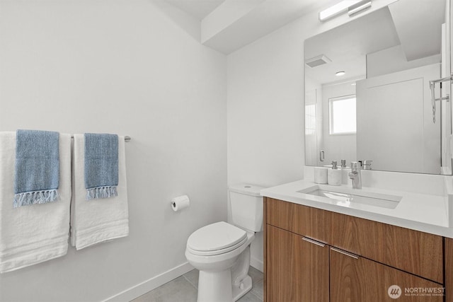 bathroom featuring vanity, baseboards, visible vents, tile patterned flooring, and toilet