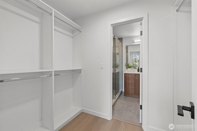 spacious closet featuring light wood-style floors