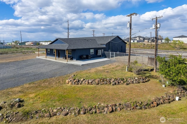 back of property featuring a patio area and a lawn