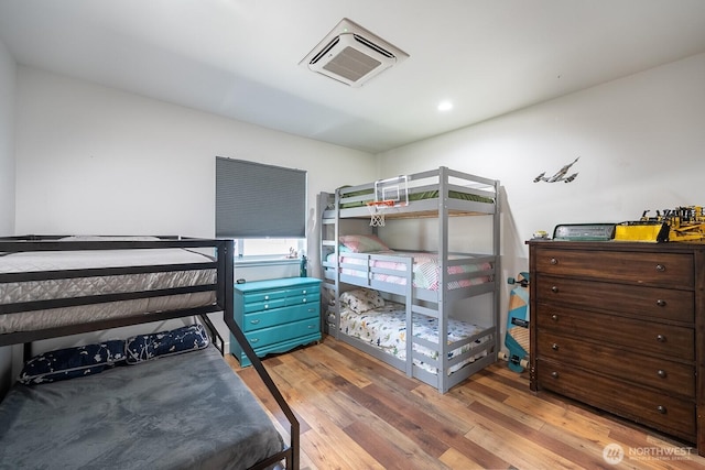 bedroom with wood-type flooring